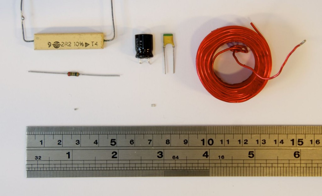 Light Column, Top to bottom: (1) A power resistor (2) a resistor (3) an SMD resistor. Middle column has two capacitors on top and an SMC capacitor below. The Right side is an inductor.